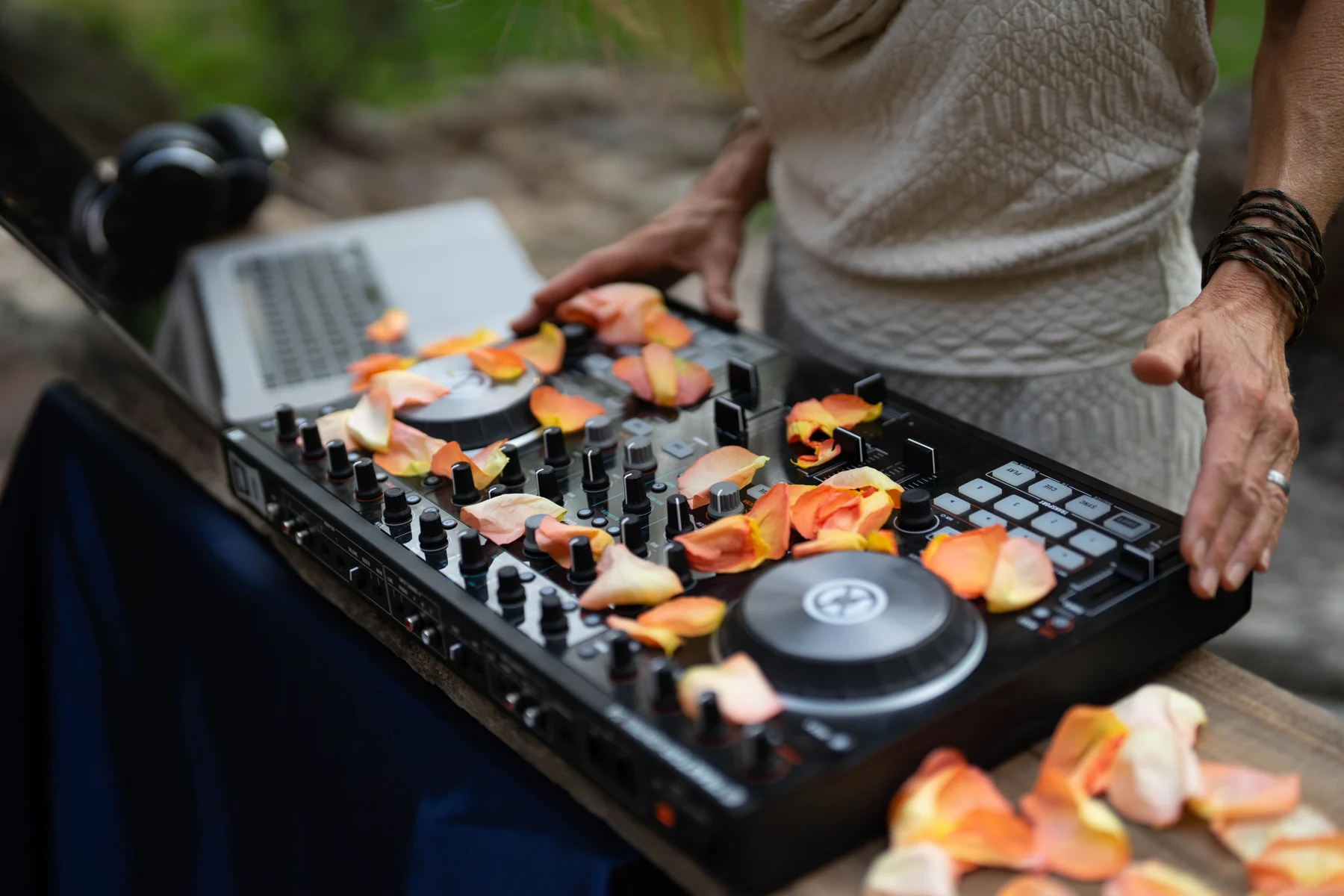 Rose petals scattered over Asha’s DJ controller